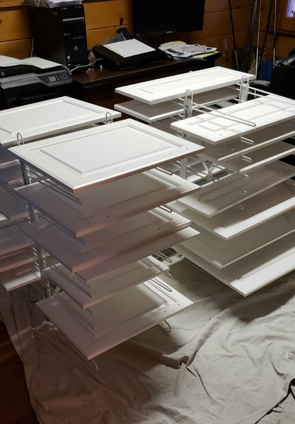 2 PRODRYINGRACK TT (PDRTT) IN USE ON FLOOR WITH WHITE CABINET DOORS DRYING ON RACK