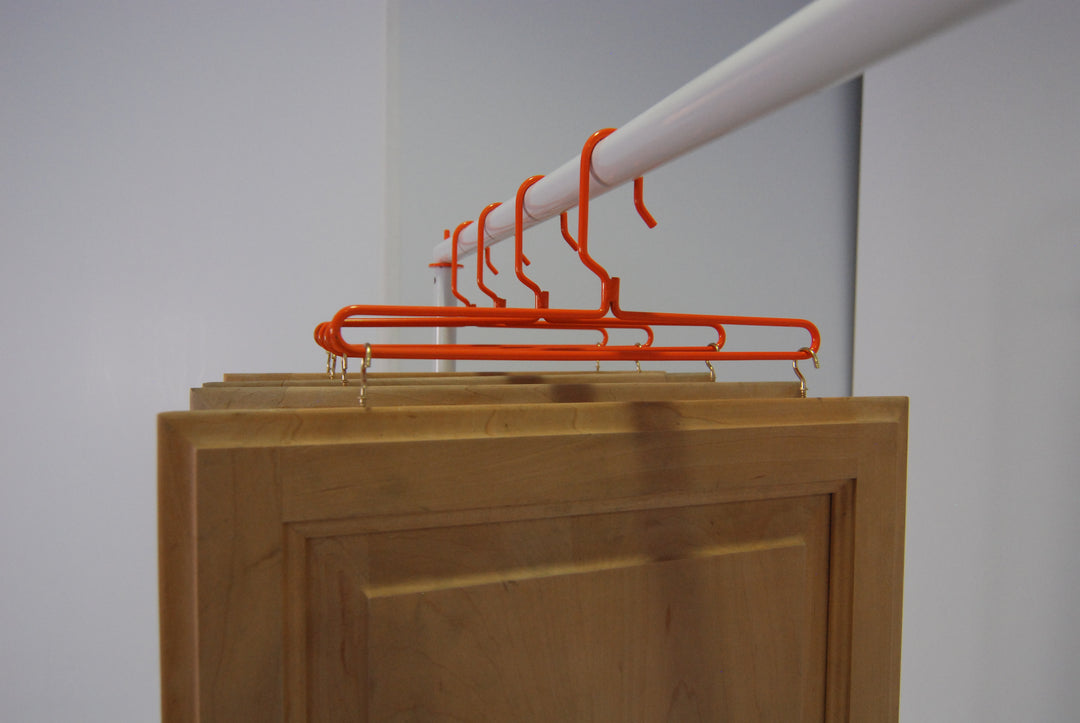 PRODRYINGRACK SD (PSDR) SERIES STANDARD HANGERS IN USE WITH CUP HOOKS AND BROWN CABINET DOORS HANGING TO DRY