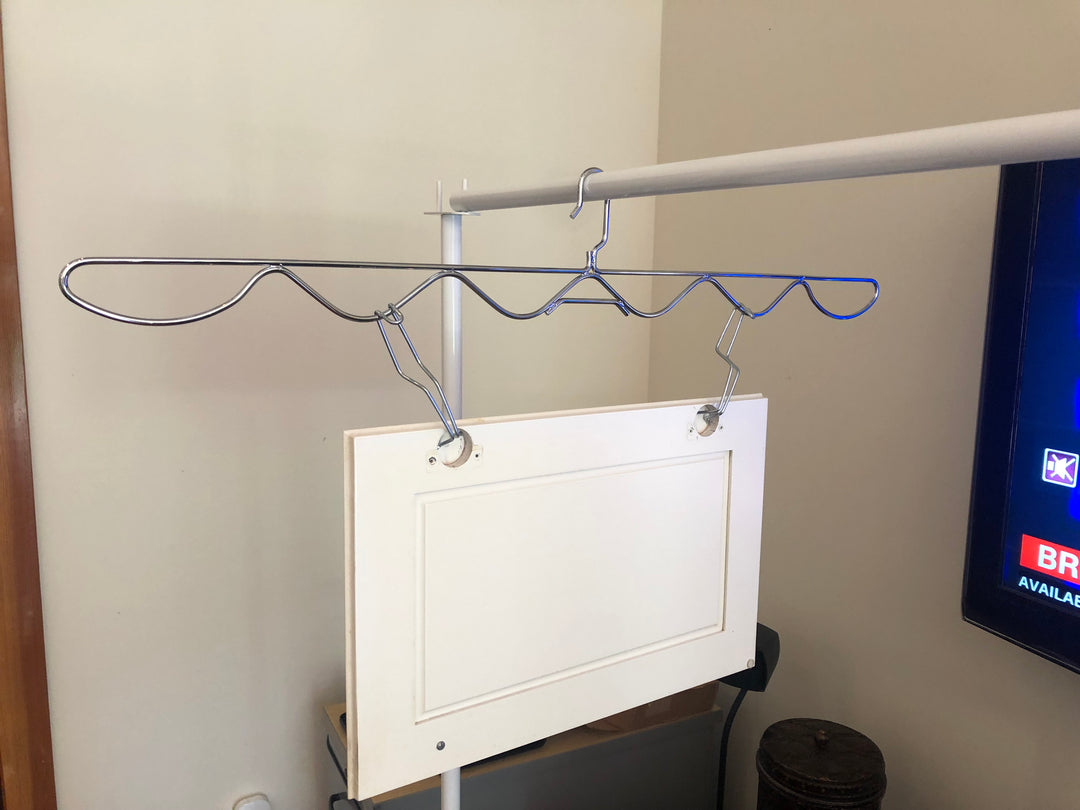 PRODRYINGRACK SD (PSDR) SERIES WAVE HANGERS IN USE WITH EFC HINGE HOOKS AND WHITE CABINET DOOR