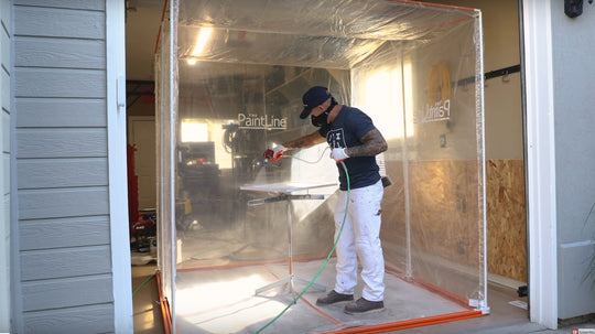 SPRAYTWIRLY (SPTY) BEING USED BY CUSTOMER TO SPRAY A WHITE CABINET DOOR INSIDE PORTABLE JOBSITE SPRAY BOOTH