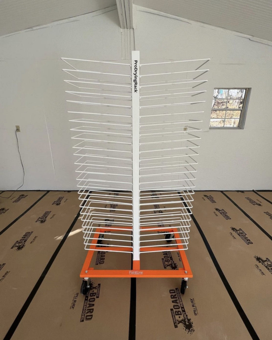 White wire rack with orange base, used to hold cabinet doors for drying and organization