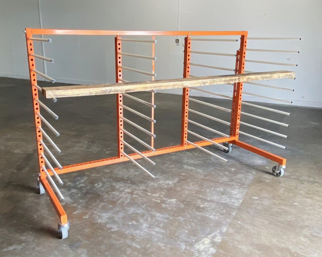 Orange metal rack with 4 towers and 10 levels of white shelves, holding a piece of long plywood