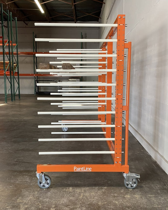 Side view of an orange metal rack with 4 towers and 10 levels of white shelves, holding a piece of long plywood