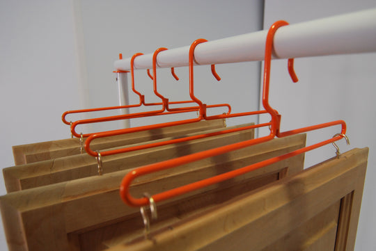 PRODRYINGRACK SD (PSDR) SERIES CUP HOOKS AND STANDARD HANGERS IN USE ON DRYING RACK WITH HANGING CABINET DOORS