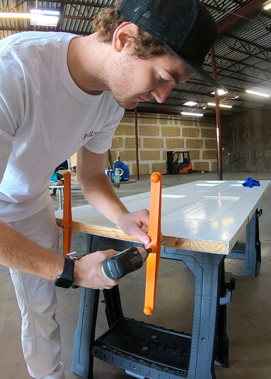 INTERIOR DOOR SPRAY AND DRY SERIES (PSDRID) DOOR BASE SUPPORTS BEING SCREWED ONTO BOTTOM OF INTERIOR DOOR