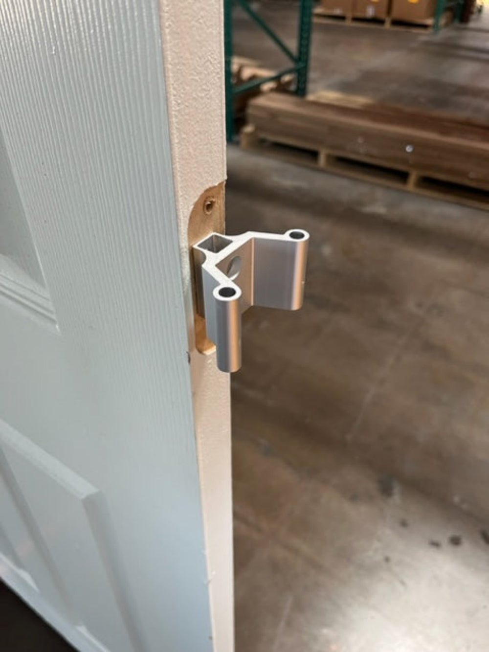 Closeup of the metal VClips attached to the hinge pocket of an interior door