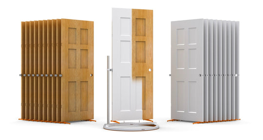 Interior Door Spray and Dry Series with brown unfinished doors standing to the left of the turntable, one door being painted white on the turntable in the center, and the finished white doors standing to the right of the turntable