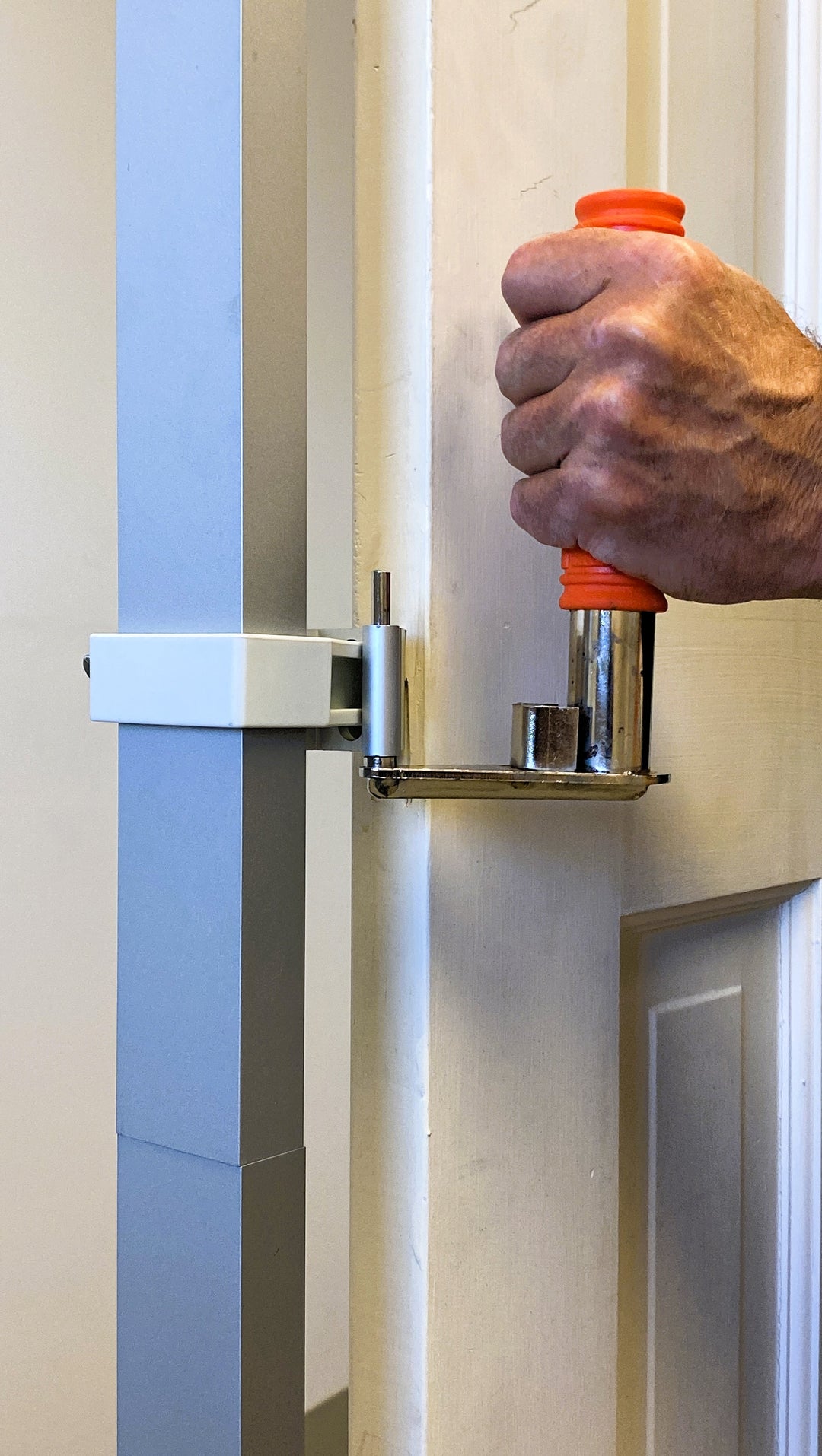 INTERIOR DOOR SPRAY AND DRY SERIES (PSDRID) CUSTOM ORANGE HAND GRIPS IN USE TO MOVE A WET DOOR OFF THE ROTATING TURNTABLE