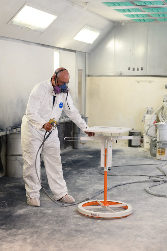 SPRAYTWIRLYHD (SPTYHD) ROTATING SPRAY TABLE BEING USED TO SPRAY WHITE CABINET DOOR IN WORKSHOP