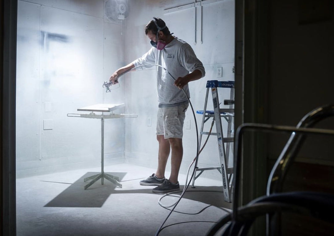 SPRAYTWIRLY (SPTY) BEING USED BY CUSTOMER TO SPRAY WHITE CABINET DOOR ON ROTATING SPRAY TABLE