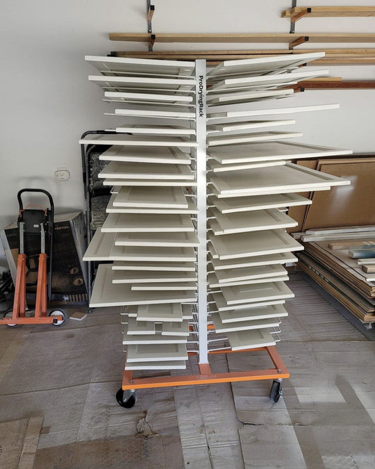 PaintLine 50-shelf ProDryingRack KD filled with white cabinet doors in a garage setting