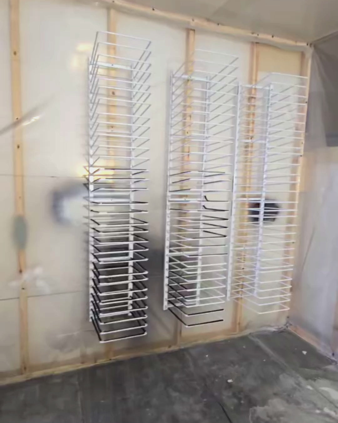 PaintLine's 15-shelf wall mount cabinet door drying rack being used by customers in multiple workshop settings.