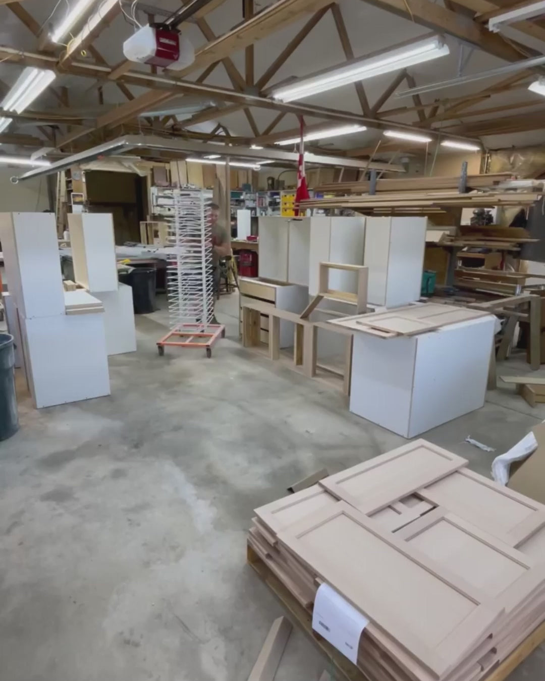 PaintLine's 50-shelf cabinet door drying rack being used by customers in multiple workshop settings.