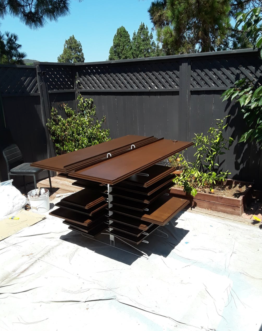 PRODRYINGRACK TT (PDRTT) IN USE OUTSIDE WITH BROWN CABINET DOORS DRYING ON RACK