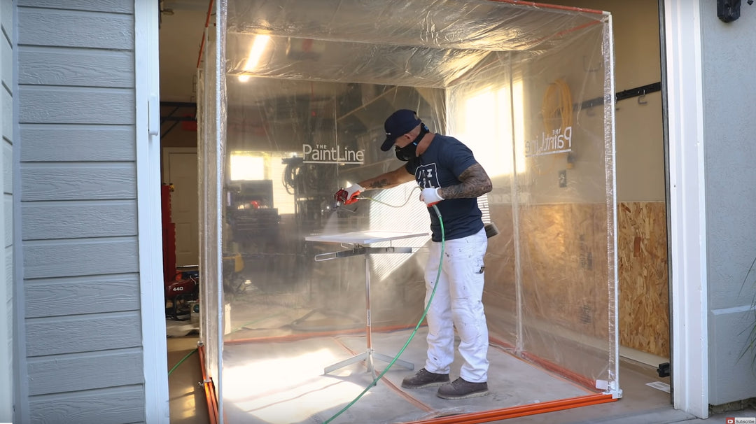 SPRAYTWIRLY (SPTY) BEING USED BY CUSTOMER TO SPRAY A WHITE CABINET DOOR INSIDE PORTABLE JOBSITE SPRAY BOOTH